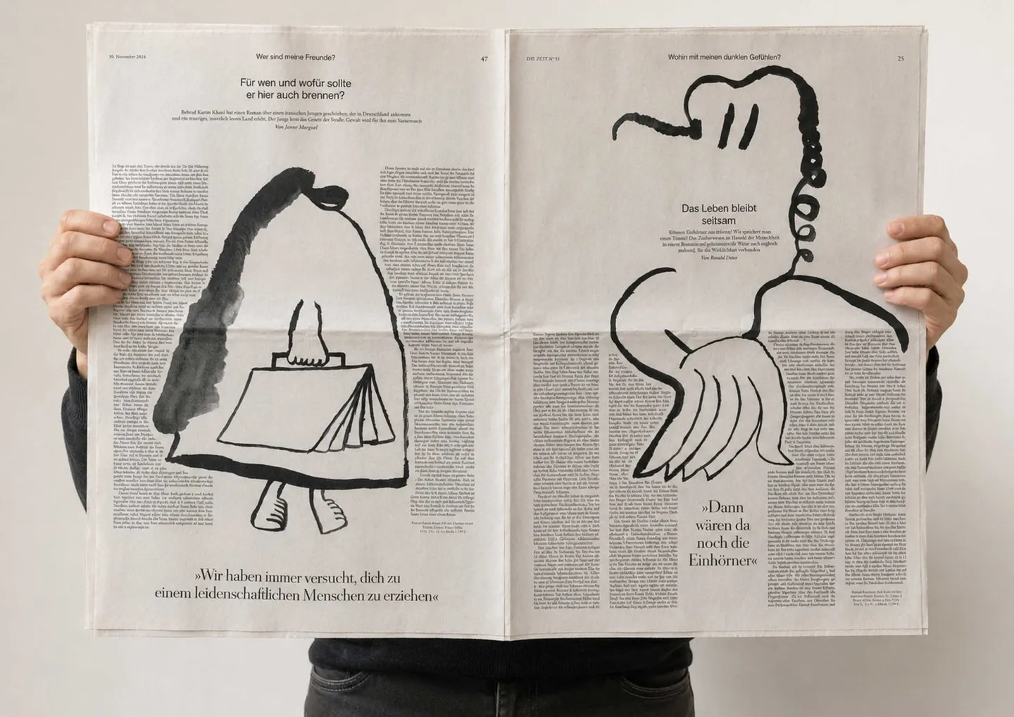 คนกางหนังสือพิมพ์ Die Zeit ที่มีภาพประกอบหมึกดำรูปคนสองตัวเต็มหน้า