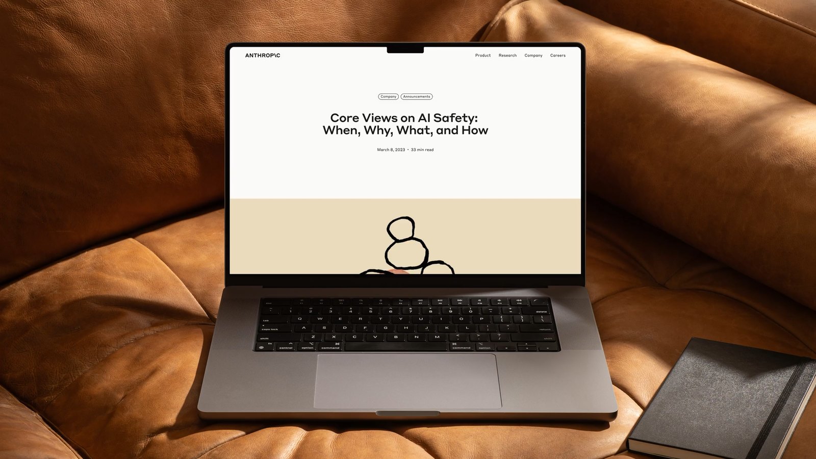 หน้าบทความ Core Views on AI Safety บนจอแล็ปท็อปที่วางอยู่บนโซฟาหนัง