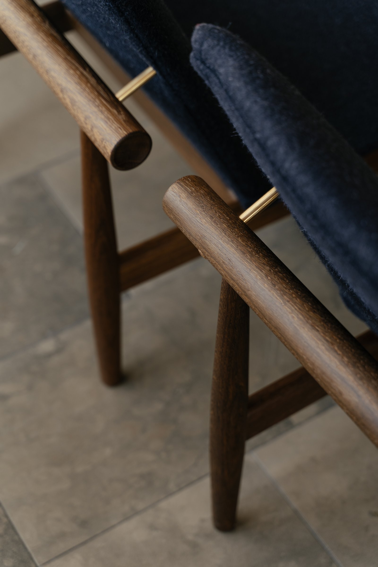 Finn Juhl Japan Chair detail showing walnut frame and upholstery separation